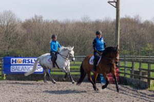 Amy and Vikki Smith cantering Laburnam Richard and JP Corbally 